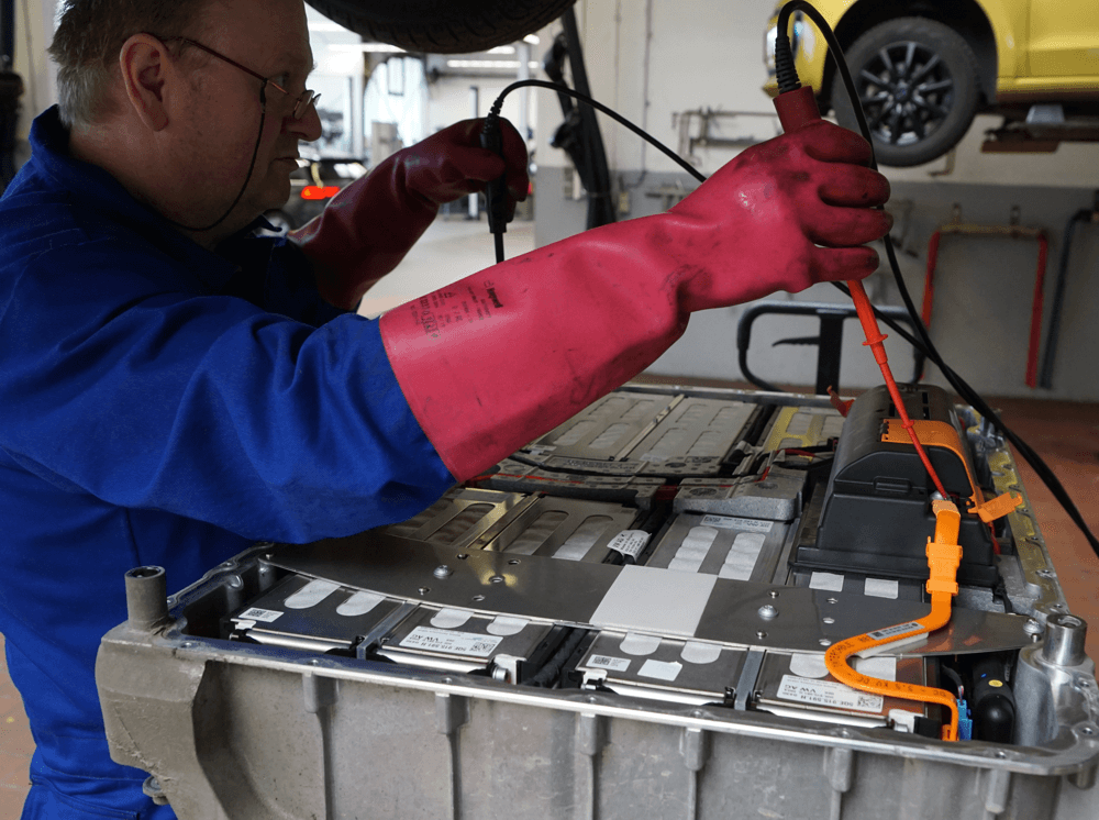 Hochvoltspezialist überprüft eine ausgebaute Batterie eines E-Autos in der Werkstatt in Michelstadt, dem Batteriekompetenzzentrum für Ihr Elektroauto. 